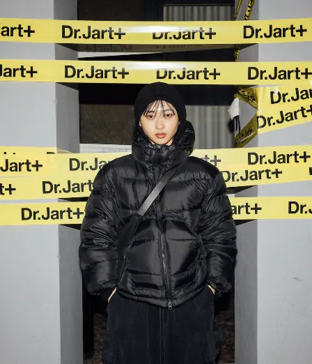 Jihoon standing within the graphic Dr.Jart+ tape installation