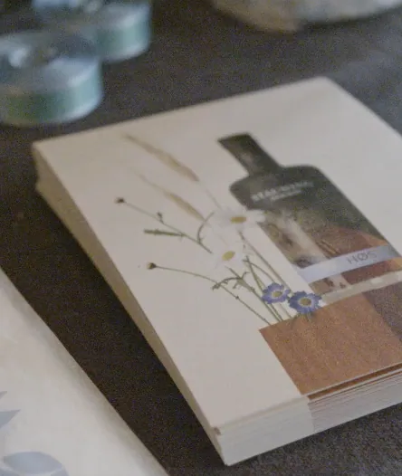 Stack of STAUNING høst books decorated with pressed wildflowers