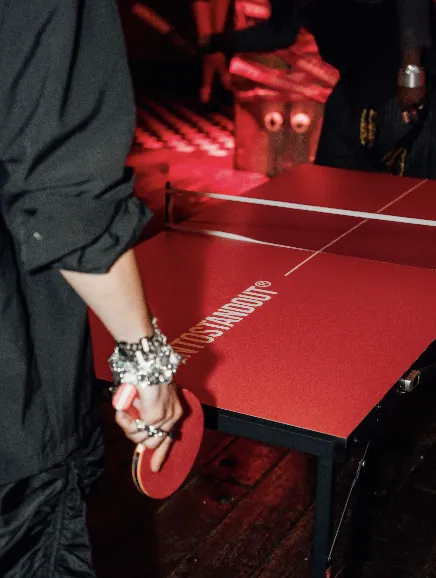 Close view of the red BORNTOSTANDOUT table tennis setup