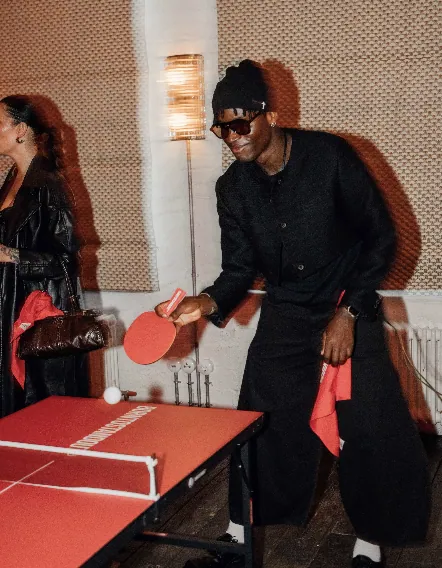 Guest playing table tennis at the BORNTOSTANDOUT game night