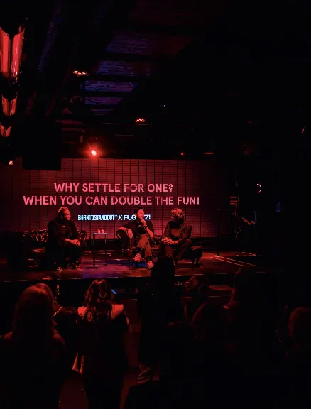 Founders speaking on stage beneath the double the fun launch message