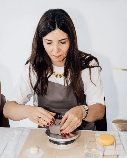 Véronique Le Bihan shaping clay on a pottery wheel