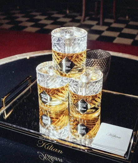 Kilian PARIS Angels' Share fragrance bottles displayed on a black mirrored tray