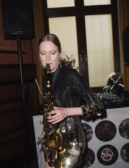 Saxophonist in a sequinned dress performing at the pomegranoudh launch