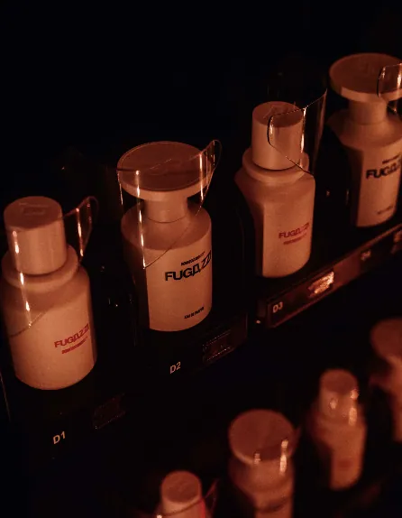 FUGAZZI fragrances presented in red event light