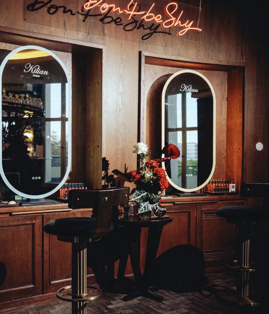 Kilian PARIS beauty station with illuminated mirrors and the neon words don't be shy